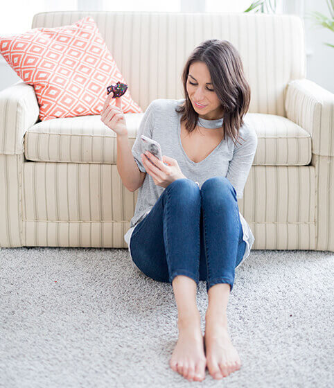 Woman using smartphone in living room