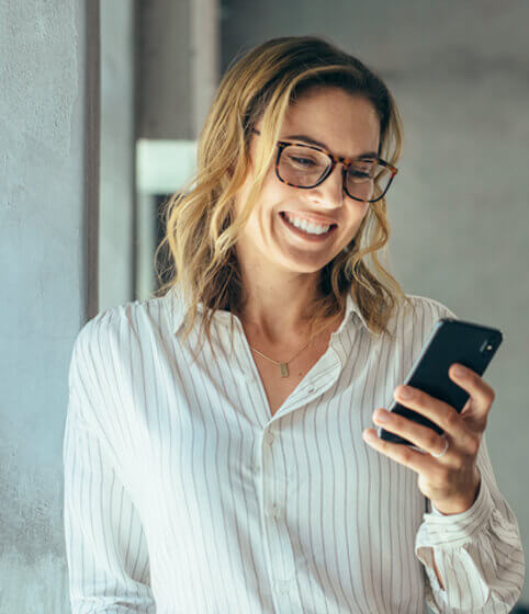 Woman smiling looking at her phone